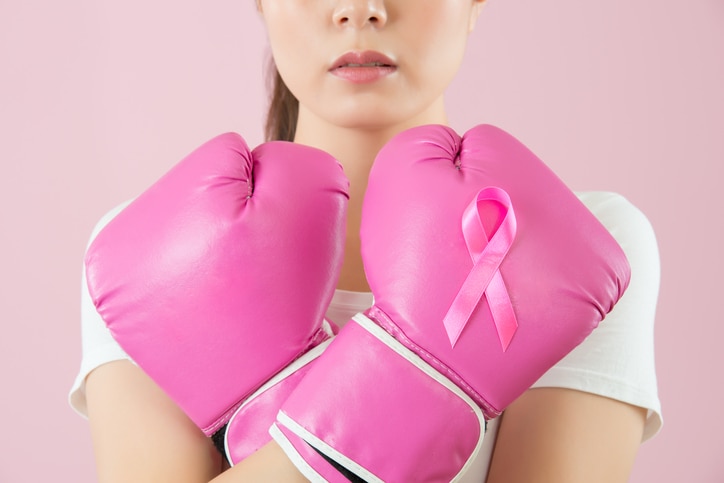 Chinese girl wear boxing gloves crossed arms