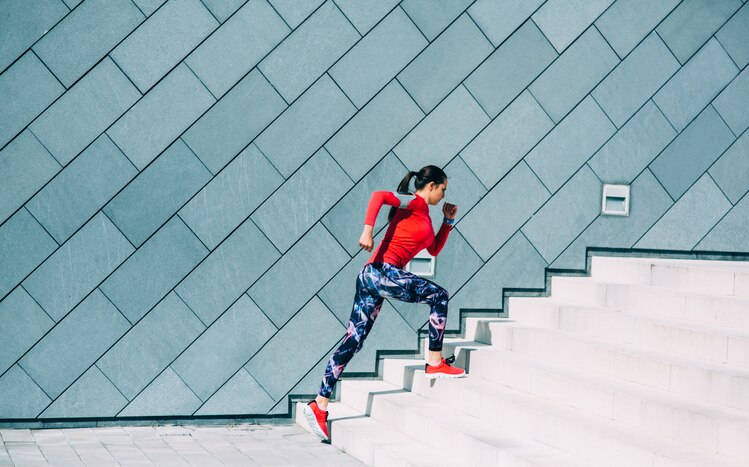 Woman exercising on a staircase outside in the  city.