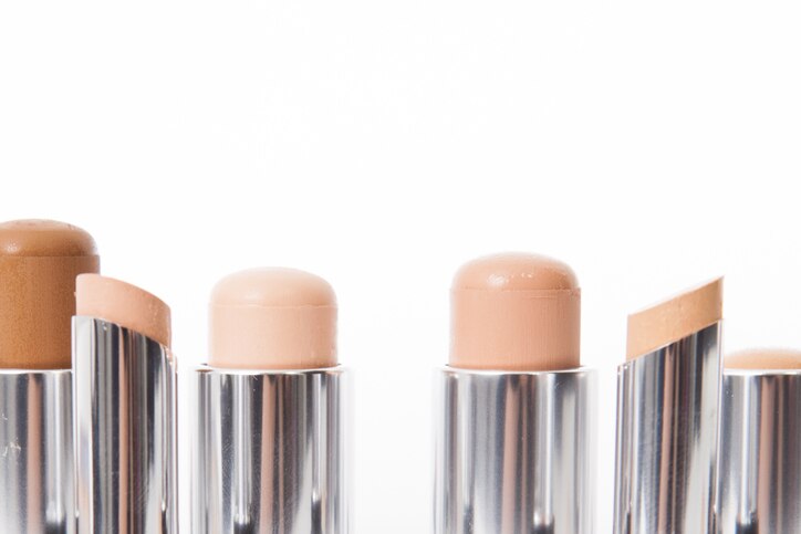 Close-up of make-up concealer sticks in different shades of beige