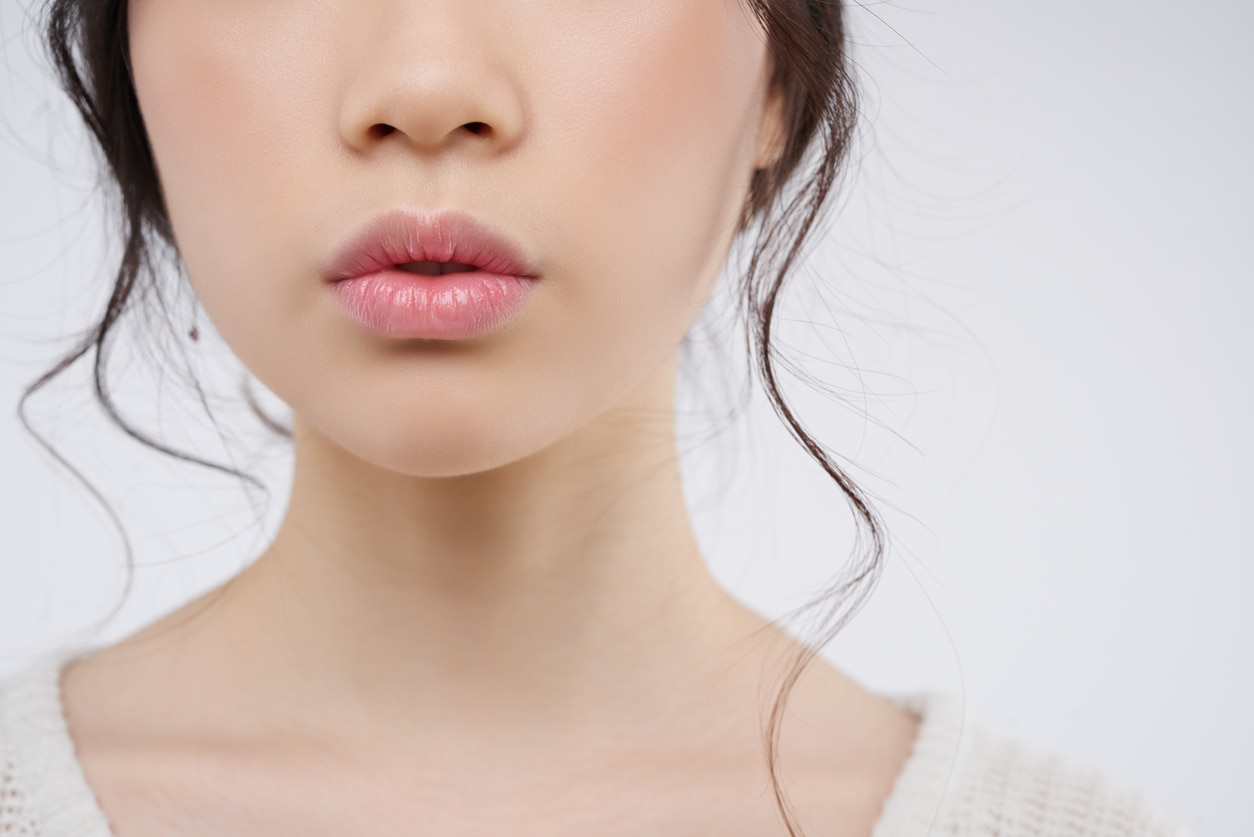 Cropped image of young woman with plump lips