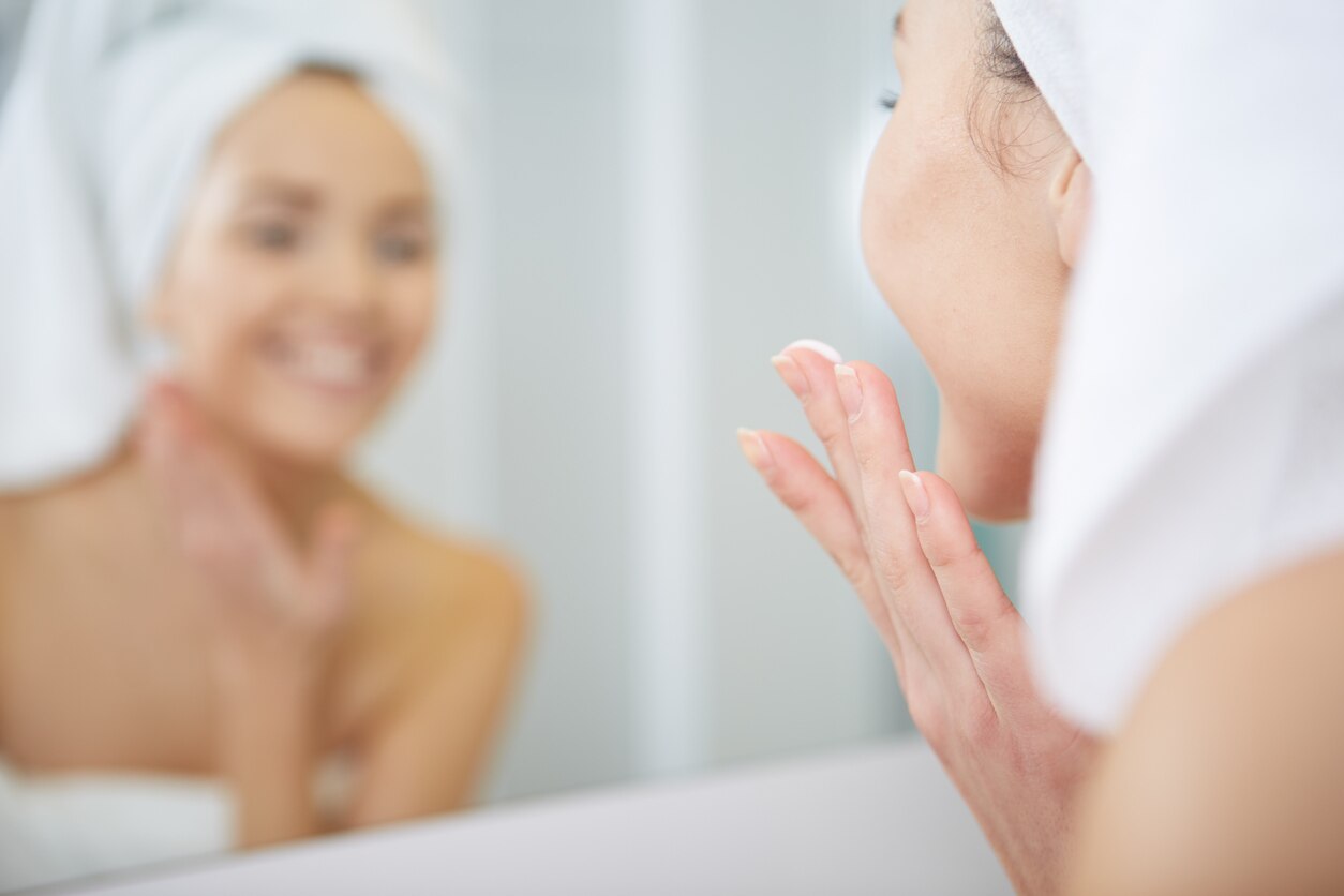 Woman applying facial moisturizing cream.Skincare concept