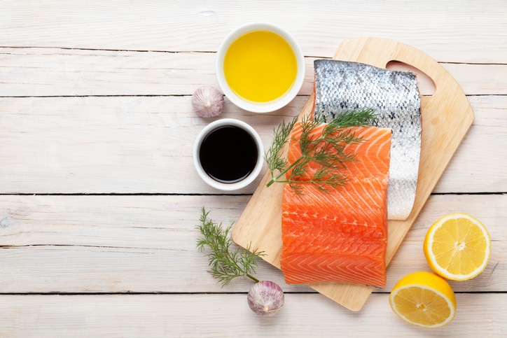 Salmon, spices and condiments on wooden table. Top view with copy space 三文魚 魚油