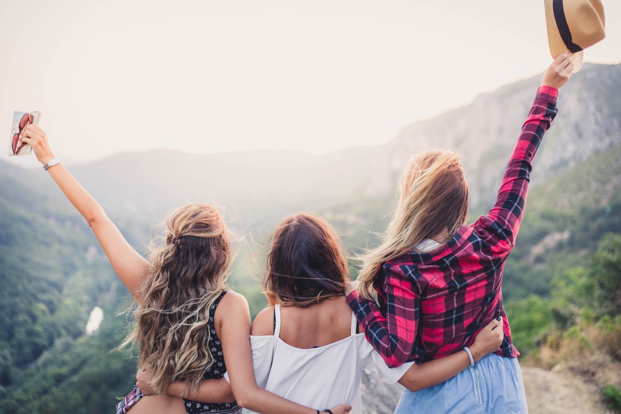 Girlfriends on viewpoint enjoying in nature