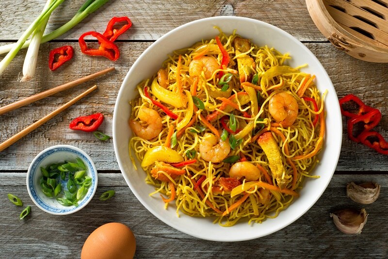 Delicious Singapore style noodles with curry, shrimp, bbq pork, carrots, red pepper, onion and scallions.